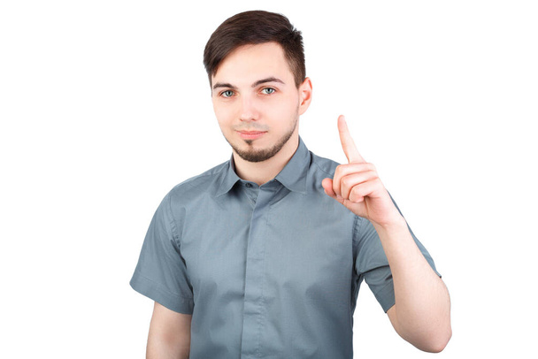 Young man with a forefinger up, "got idea" gesture, isolated. Casually handsome. Confident young handsome man while standing against white background. Happy Young Man Isolated Background. - Fotó, kép