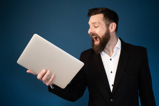 angry businessman shouting at laptop - Fotó, kép