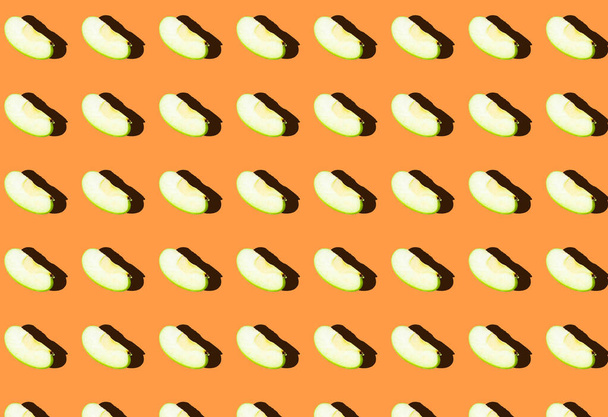A pattern with green apple slices on an orange background. Prints, templates. - Photo, Image