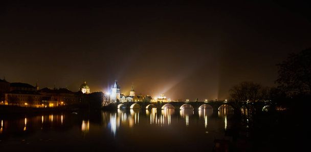 PRAGUE, CZECH REPUBLIC - Jan 01, 2021: Prague, Czech Republic - January 1 2021  Night view of the Charles Bridge - Photo, Image
