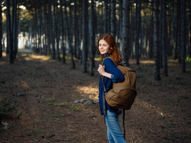 Woman in blue shirt with a backpack on her back jeans travel model - Photo, Image