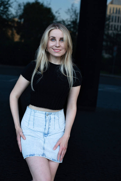 Blond hair white young woman in skirt smiling - Fotó, kép