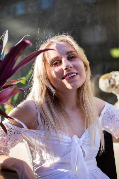Romantic blond hair european white model with a plant - Fotoğraf, Görsel