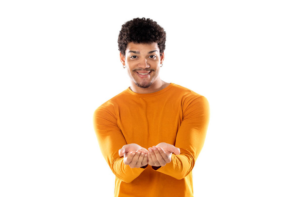 Smiling afro guy offering something isolated on a white background - Zdjęcie, obraz