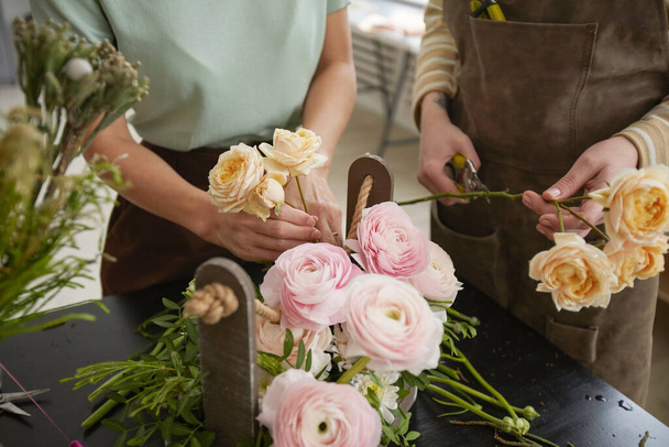Close up of beautiful flower composition with roses and peonies on table in florist workshop, copy space - Photo, Image
