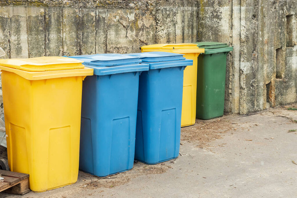 Blue and yellow trash cans or garbage bins outdoors - Photo, Image