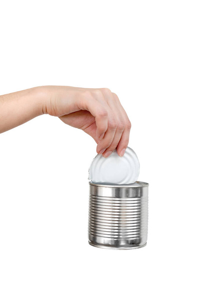 Female hand holding empty tin can. Recyclable waste. Recycling, reuse, garbage disposal, resources, environment and ecology concept. - 写真・画像