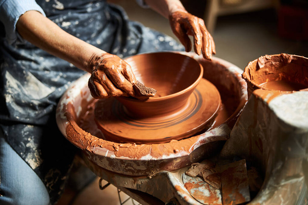 Female potter hands making clay pot in pottery workshop - Photo, Image
