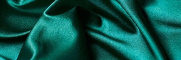 Abstract green background luxury cloth or liquid wave or wavy folds of grunge silk texture satin material. - Photo, image