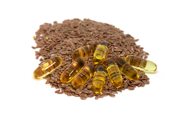 Gelatin capsules with omega 3 and flax seeds on white background - Foto, Imagem