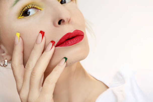 Model with multicolored makeup and French manicure. - Zdjęcie, obraz