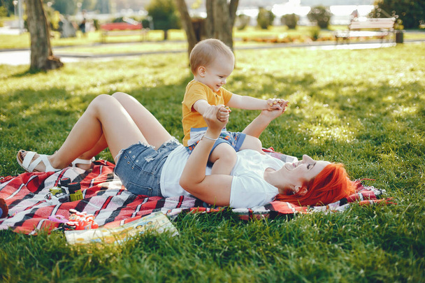 Mother with son playing in a summer park - Фото, зображення