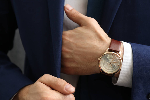 Businessman in jacket with luxury wrist watch, closeup - Foto, imagen