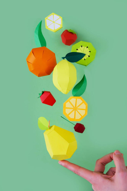 exotic fruits made of paper on green background. Levitation from fruits - Foto, afbeelding