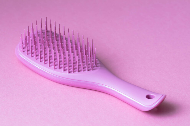 Rosa Haarbürste isoliert auf rosa Hintergrund - Foto, Bild