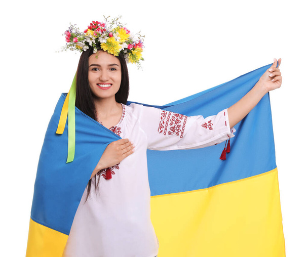 Young woman in national clothes with flag of Ukraine on white background - Foto, afbeelding