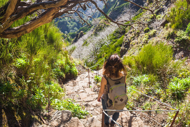 Beautiful hiking trail Trekking from Pico do Arieiro to Pico Ruivo Madeira island Portugal. Tourist girl with backpack. Breathe escape solo tourism concept. Scenic background, nomad wallpaper - Photo, image