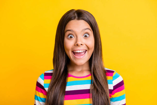 Photo of cute little girl excited face open mouth wear striped shirt isolated yellow color background - 写真・画像