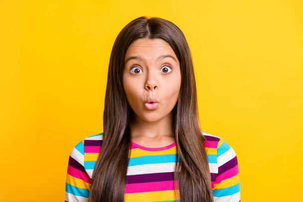 Photo of pretty small girl shocked expression staring wear striped shirt isolated yellow color background - 写真・画像