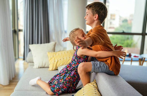 Cute little kids, siblings hug and cuddle at home show love and care. Family children support concept - 写真・画像