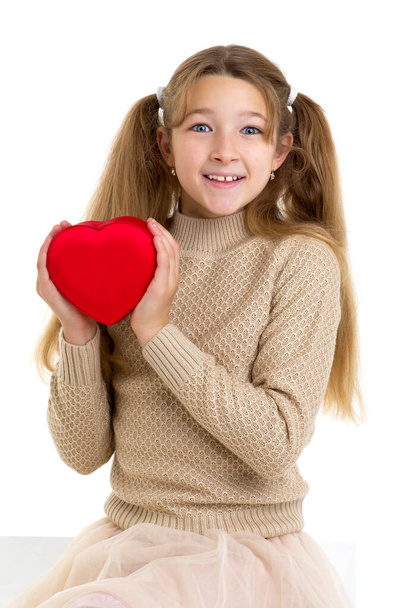 Beautiful girl holding red heart. Studio portrait. - Photo, Image