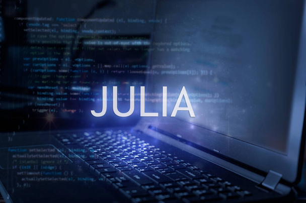 Julia felirat laptoppal és kódolt háttérrel. Technológiai koncepció. Programozási nyelv tanulása. - Fotó, kép