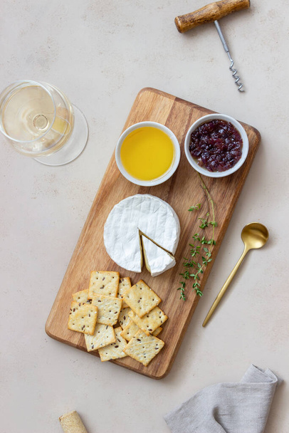 Τυρί καμαμπέρ με κράκερ, μέλι και μαρμελάδα. Κρασί σνακ - Φωτογραφία, εικόνα