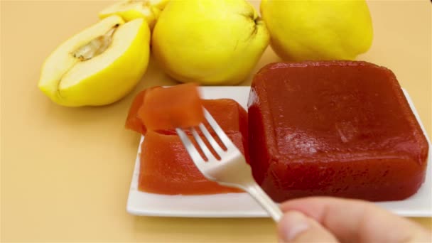 Showing a delicious homemade quince jam, homemade quince flesh, on a creamy background, with quinces out of focus in the background - Footage, Video