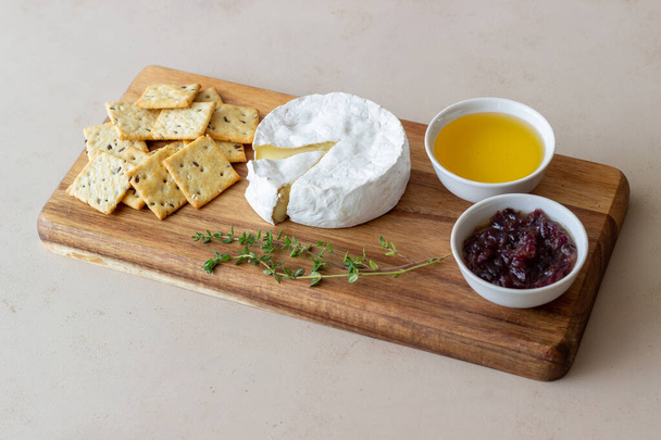 Camembert cheese with cracker, honey and jam. Wine snack - Photo, image