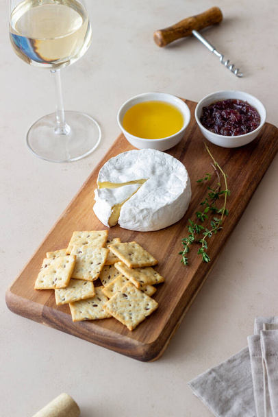 Camembert cheese with cracker, honey and jam. Wine snack - Photo, image