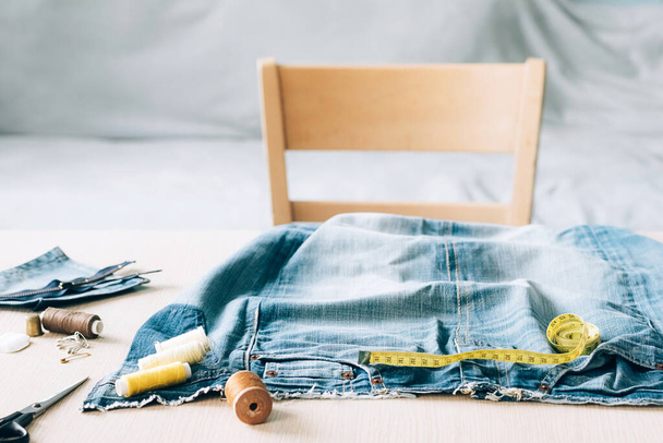 The concept of reusing old recyclable materials. Sewing and repair denim clothes - Fotoğraf, Görsel