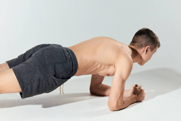 bodybuilder athletic guy push ups indoors elbows workout - Fotografie, Obrázek