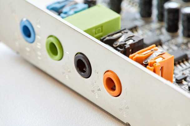 Multi-colored analog sound card outputs and inputs. Close-up, selective focus - Fotó, kép