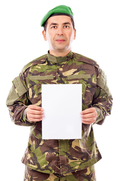 Young soldier holding white sheet of paper - Foto, imagen