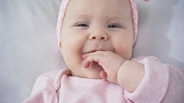 top view of infant baby sucking fingers - Photo, Image
