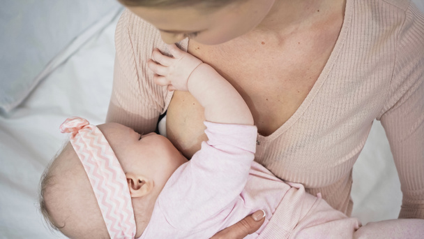 overhead view of woman breastfeeding baby at home - Photo, Image