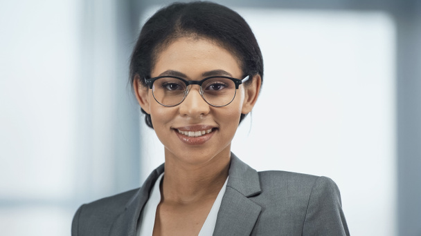 happy african american businesswoman in glasses looking at camera - Photo, image