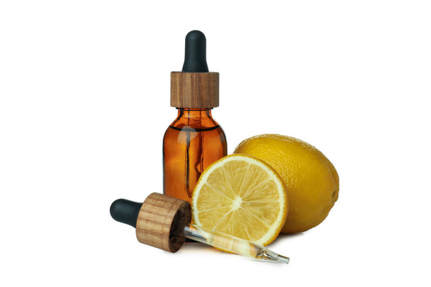 Dropper bottle with oil and lemons isolated on white background - Photo, image
