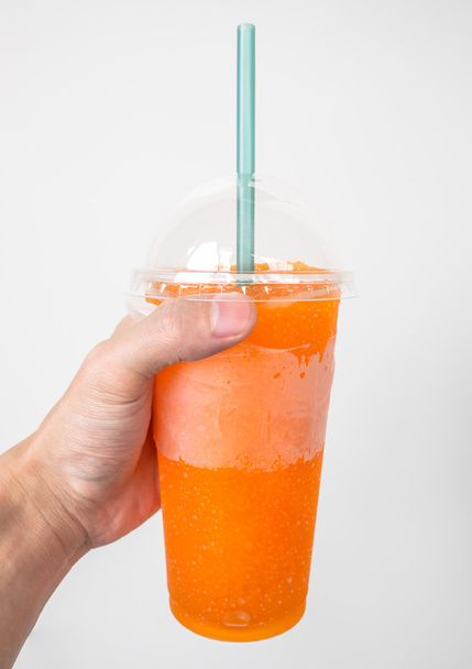 Hand holding orange soft drink - Photo, Image