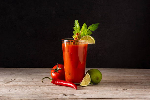 Bloody Mary cocktail in glass on rustic wooden table - Photo, Image