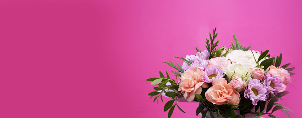 Bouquet of mixed flowers in hand on pink background banner with copy space - Photo, Image