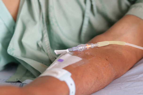 Close up of arm patients in hospital with saline intravenous. - Photo, Image