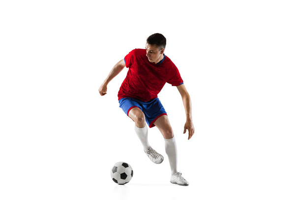 Young Caucasian soccer football player training isolated on white background. - Foto, afbeelding