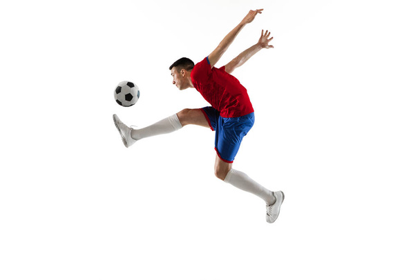 Young Caucasian soccer football player training isolated on white background. - Foto, immagini
