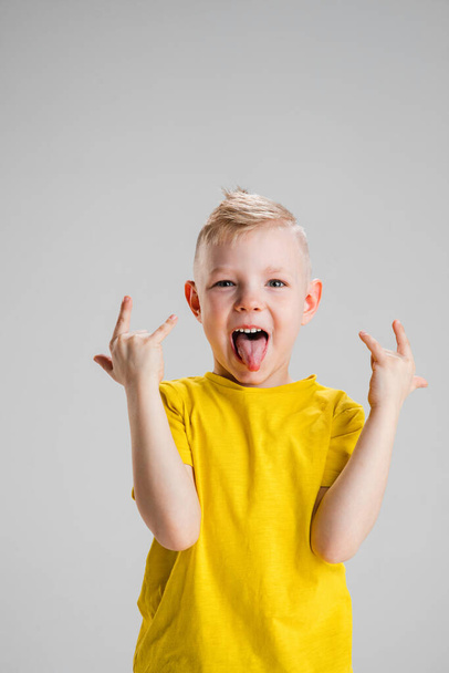 Happy boy isolated on white studio background. Looks happy, cheerful, sincere. Copyspace. Childhood, education, emotions concept - Foto, Bild