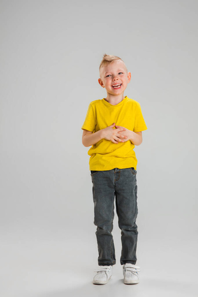Happy boy isolated on white studio background. Looks happy, cheerful, sincere. Copyspace. Childhood, education, emotions concept - Foto, Imagen