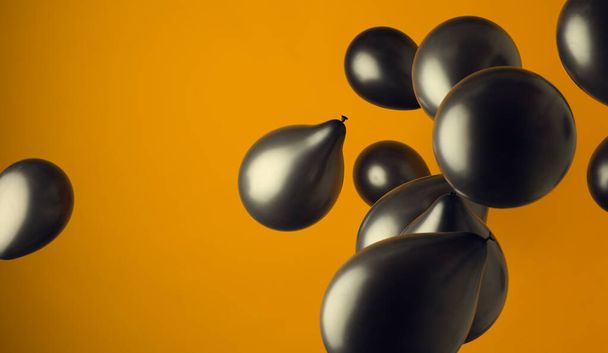 lanscape image of black ballons floting in front of a yellow background - 写真・画像