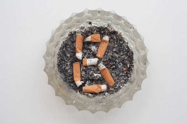 a font of letters made from cigarette butts - Фото, изображение