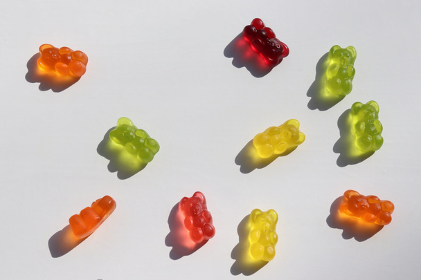Colored gummy bears on white background. Top view, copy space. Multicolored jelly candy pattern - Foto, immagini