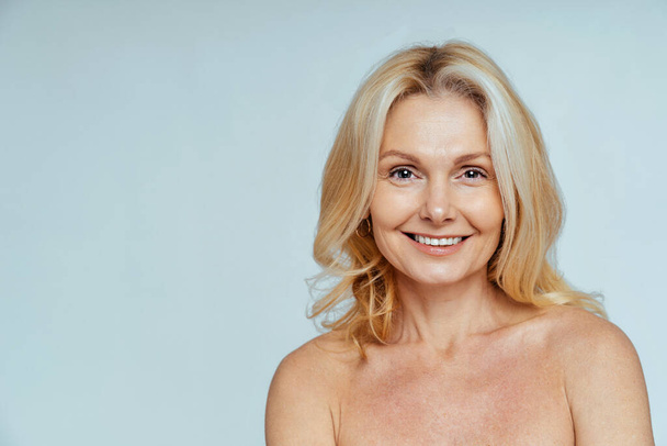 Beautiful senior woman with young and clean look, beauty shot - Pretty senior lady over 60 with perfect skin, concepts about elderly, beauty treatment and skin care - Photo, Image